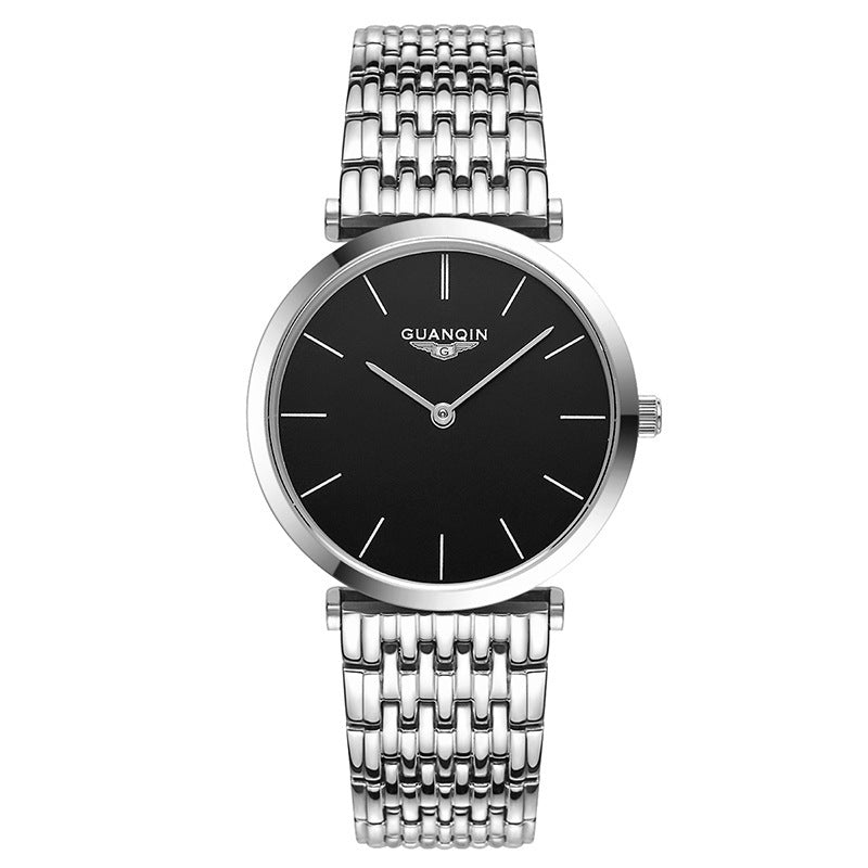 Silver watch with black face on a white background
