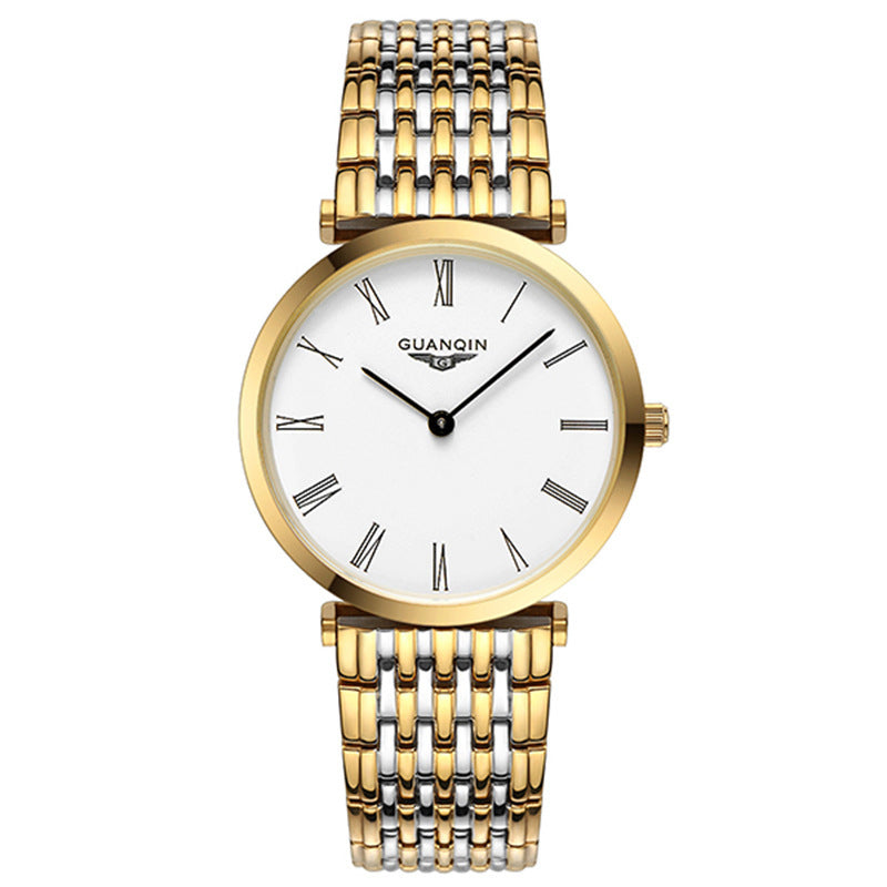 Gold and silver watch with white face on a white background