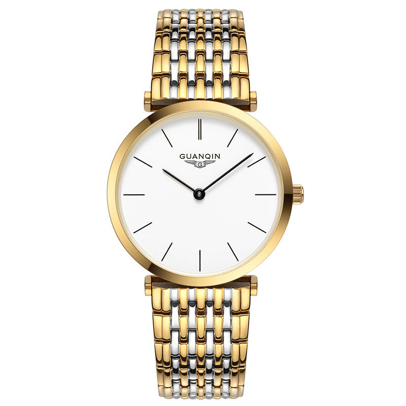 Gold and silver watch with white face on a white background
