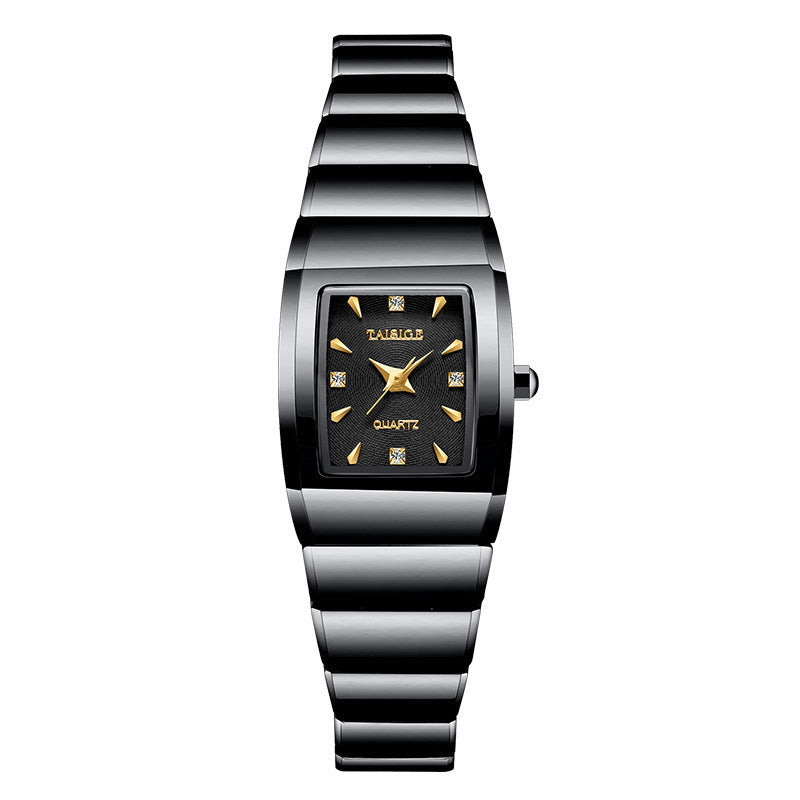 Black and silver watch with a square face on a white background