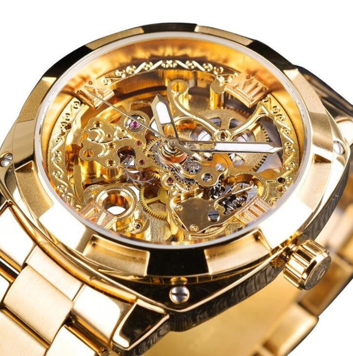 Gold wristwatch with intricate mechanical design on a white background
