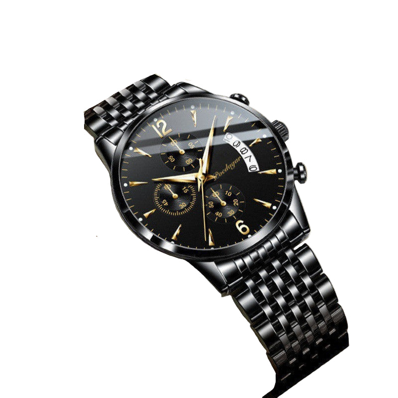 Black wristwatch with detailed face in a box, brand tag visible
