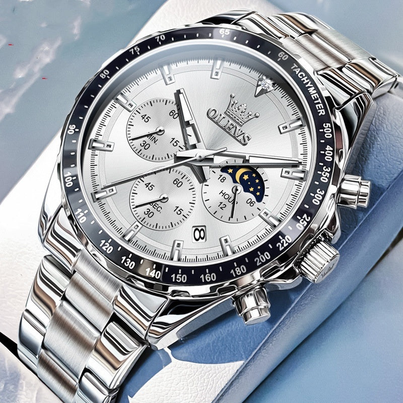 Silver wristwatch with detailed face on a light blue background