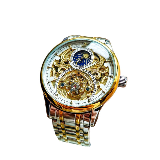 Luxury watch with gold and silver design on a wrist against a blurred indoor background