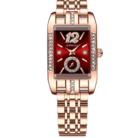 Rose gold watch with a red face on a white background