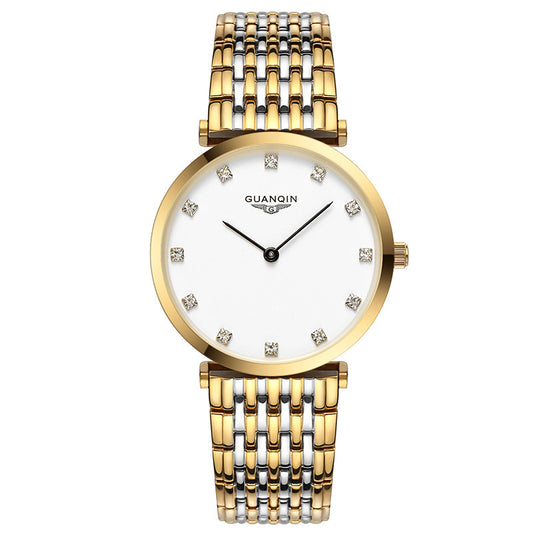 Gold watch with a white face and diamond-like accents on a white background